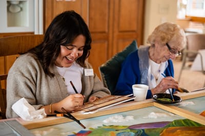 Residents and staff engaging in an art activity