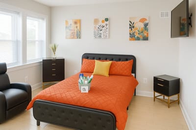 Cozy senior living room with orange bedding and decor