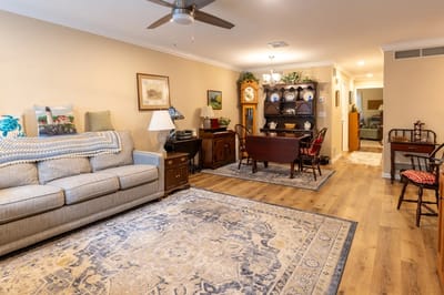 Interior view of a cozy common area with seating and dining table