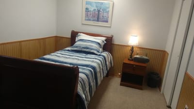 Cozy private resident room with single bed and lamp