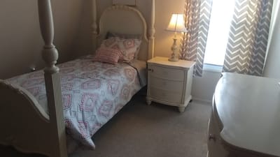 Cozy resident room with a single bed and bedside table