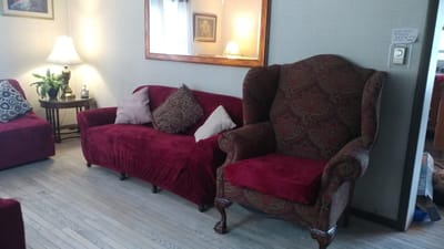Cozy interior seating area with red couches and a lamp