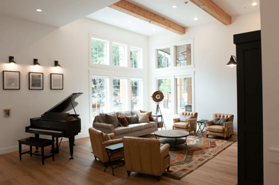 Bright common area with seating and a piano