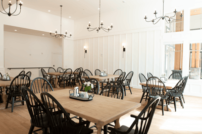 Bright dining area with black chairs and wooden tables