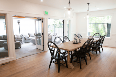 Bright common area with a wooden dining table
