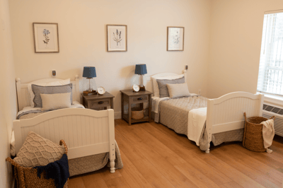 Cozy resident room with two beds and natural light