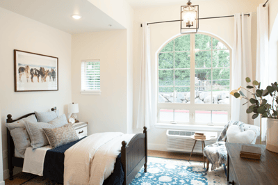 A cozy private resident room with a bed and window