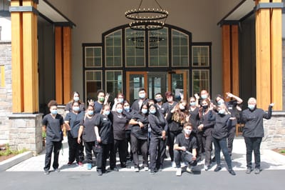 Staff members posing outside the facility entrance