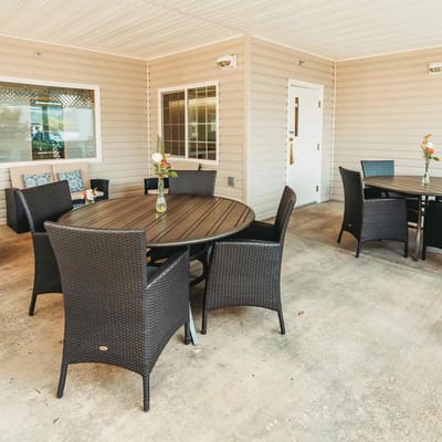 Outdoor seating area with tables and decorative flowers