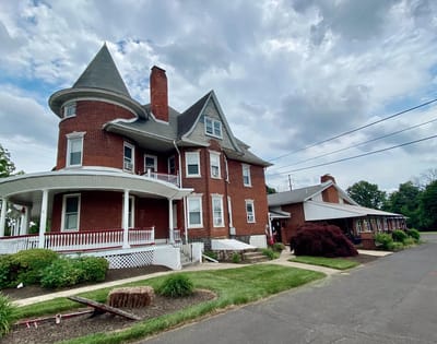Exterior view of Paradise Manor with landscaping