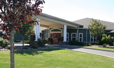 Main entrance of Wolf Run Village with landscaped surroundings
