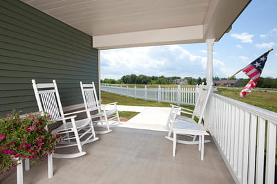 Porch with rocking chairs and a view of greenery