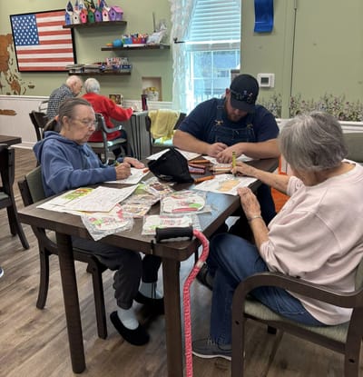 Residents engaging in an arts and crafts activity at a table