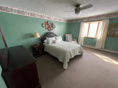 Cozy resident room with a bed and chair