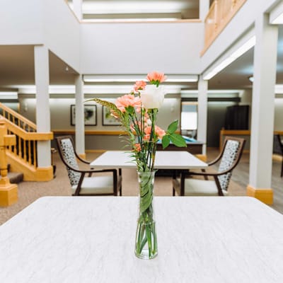Vase of flowers on a table in a common area