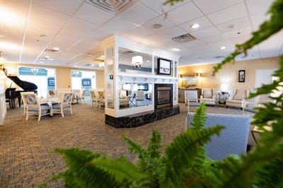 Bright common area with seating and a fireplace