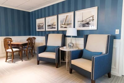 Interior lounge area with chairs and artwork