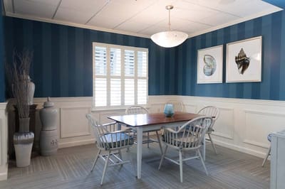 Bright and airy dining area with blue striped walls