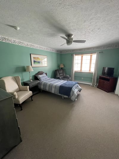 Cozy resident room with a bed and seating area