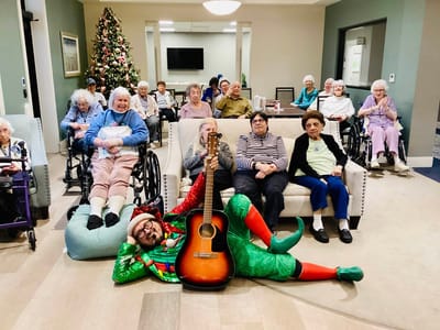 Residents enjoying a musical performance in a common area
