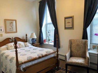 Cozy resident room with a bed and chair