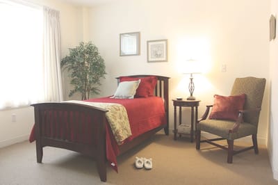 Cozy bedroom with a bed, chair, and decor