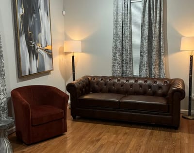 Cozy interior with brown seating and artwork