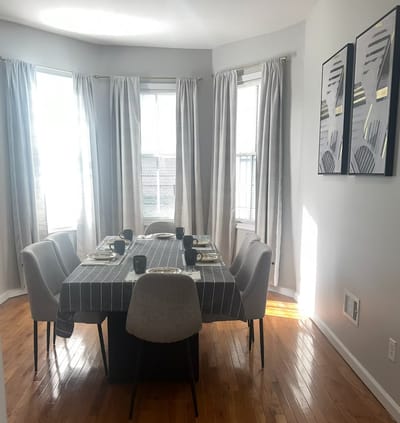 Bright dining room with a table set for meals