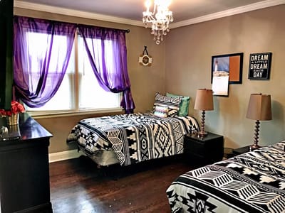 A cozy resident room with twin beds and decor