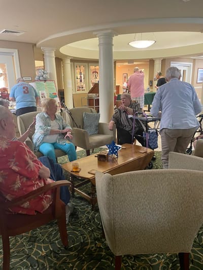 Residents socializing in a common area with seating