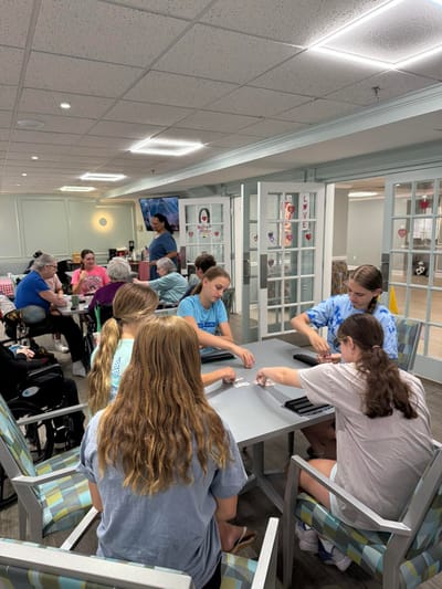 Residents and staff engaged in an activity in a common area