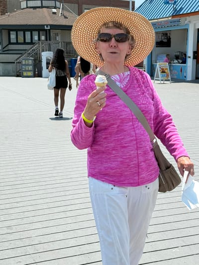 Resident enjoying ice cream on a boardwalk