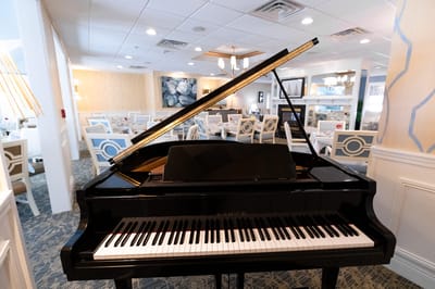 Interior view of a dining room with a grand piano