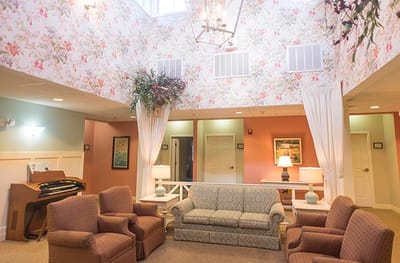 Cozy common area with floral wallpaper and seating