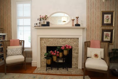 Cozy common area with decorated fireplace and chairs