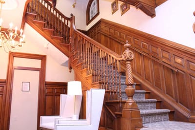 Interior view of a grand stairwell with wooden details