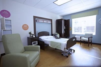 Well-furnished resident room with bed and chair