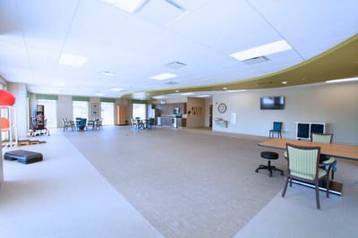 Bright and spacious common area with tables and chairs