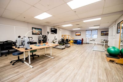 Bright and spacious physical therapy room with equipment