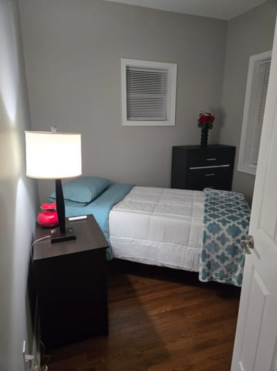Cozy private resident room with a bed and lamp