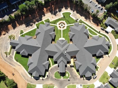 Aerial view of a senior living facility with landscaped grounds