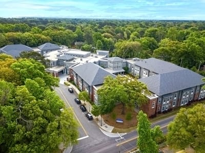 Aerial view of the senior living facility surrounded by trees