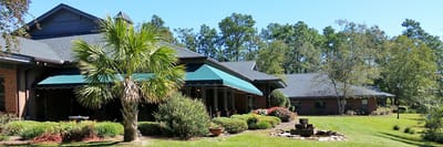 Exterior view of a senior living facility with landscaping