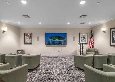 Common area with seating and a screen for movie nights