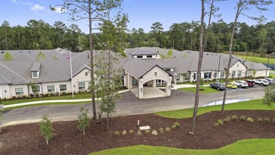 Aerial view of a senior living facility surrounded by trees