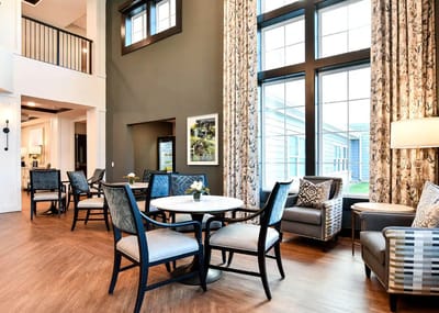 Bright common area with seating and large windows
