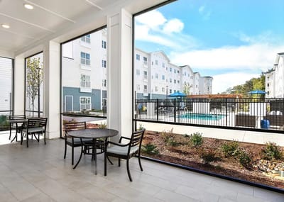 View of a patio area with seating overlooking the pool