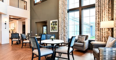 Bright common area with seating and large windows