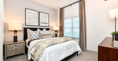 A cozy resident bedroom with neutral decor