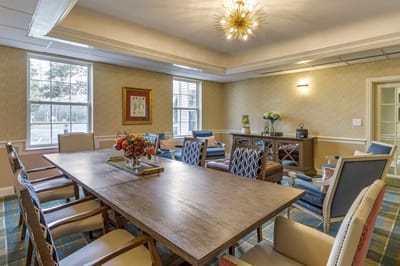 Bright common area with a large wooden table and chairs